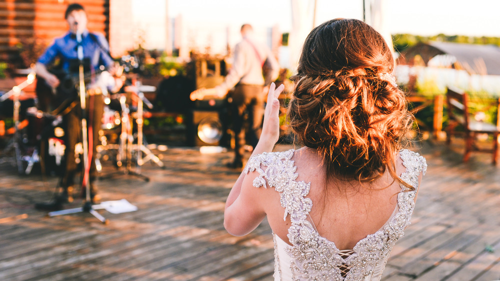 Bride clapping for her wedding band