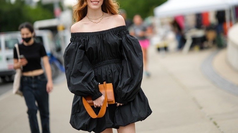 Woman walking in bubble dress and coat