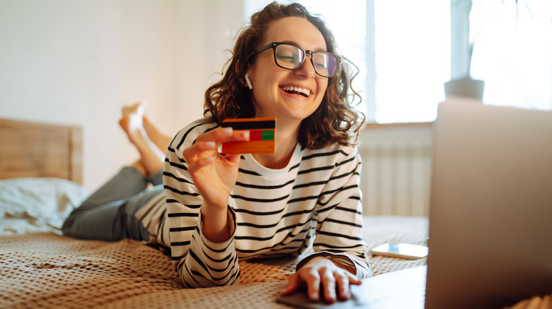 Woman shops online in bed