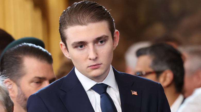 Barron Trump looks on as U.S. Democratic Leader Chuck Schumer waves to a guest during inauguration ceremonies in the U.S. Capitol Rotunda on January 20, 2025 in Washington, DC.