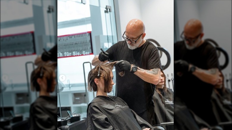 stylist using a calligraphy pen to cut hair