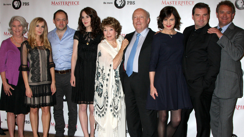 "Downton Abbey" cast posing on step-and-repeat in 2012