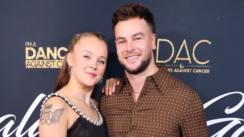 JoJo Siwa and Chris Hughes posing