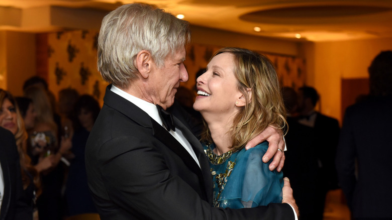 Harrison Ford and Calista Flockhart embracing and smiling