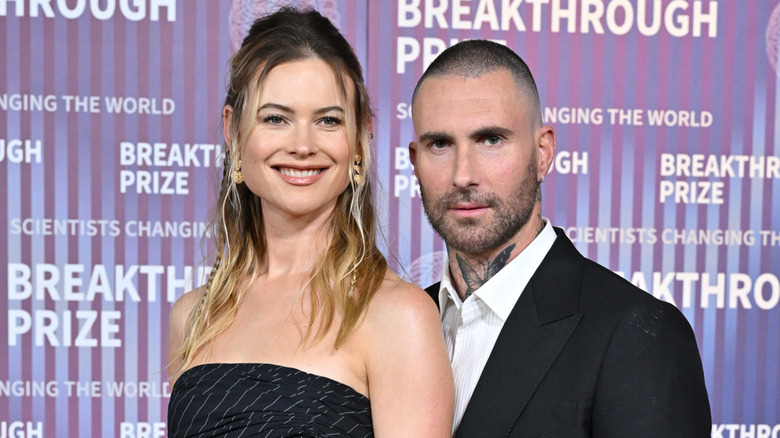 Behati Prinsloo and Adam Levine wearing black