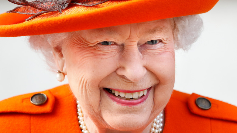 Queen Elizabeth smile orange hat