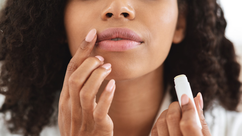 Woman applying lip balm 