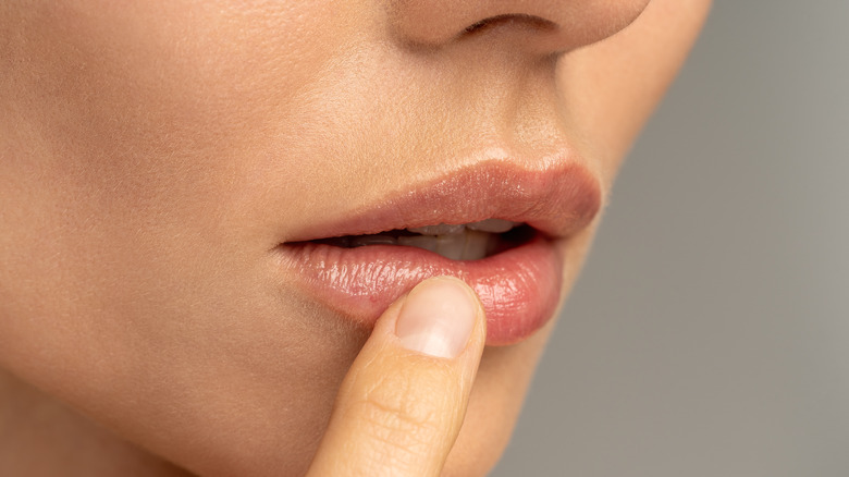Woman touching lips 