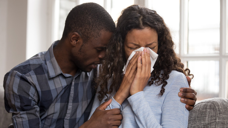 Man consoling crying woman