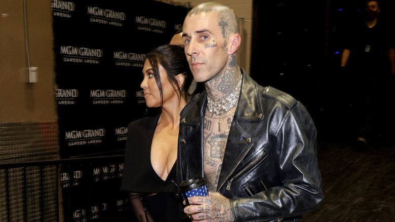 Kourtney Kardashian and Travis Barker walking