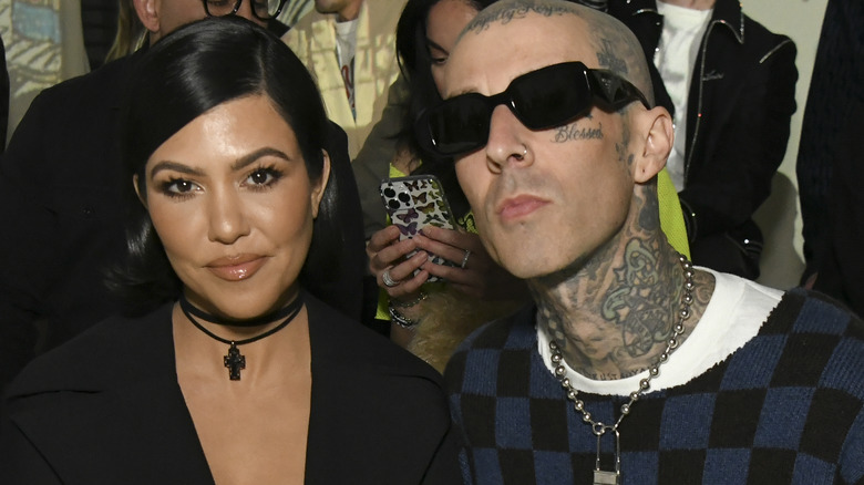 Kourtney Kardashian and Travis Barke both posing