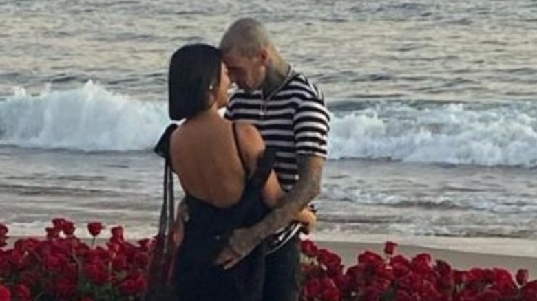 Kourtney Kardashian and Travis Barker in an embrace