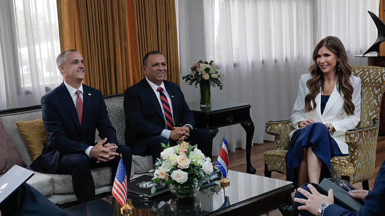 Kristi Noem smiling during a meeting with Corey Lewandowski