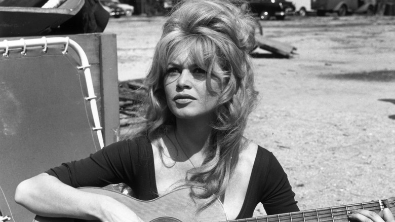 Brigitte Bardot playing guitar