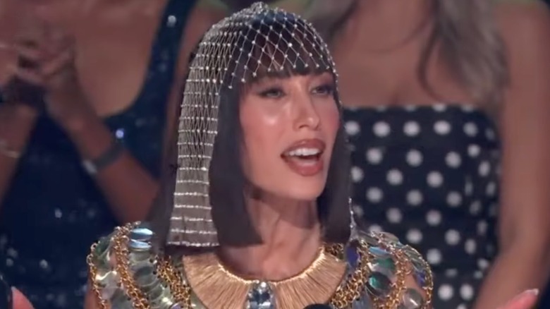 Cheryl Burke costumed as Cleopatra while behind the judging table of Dancing With the Stars