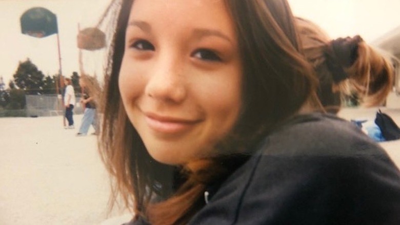 A teenage Cheryl Burke smiling