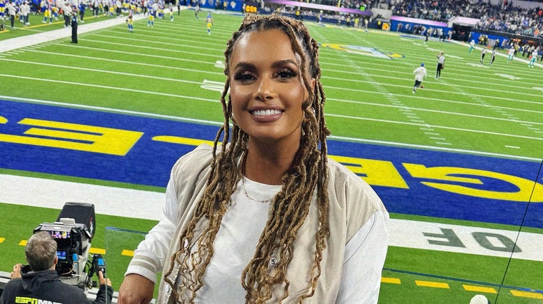 Joy Taylor smiling in front of a football field in 2024