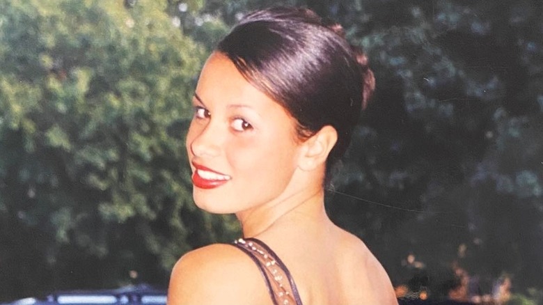 Young Joy Taylor posing outdoors at homecoming dance in 2003
