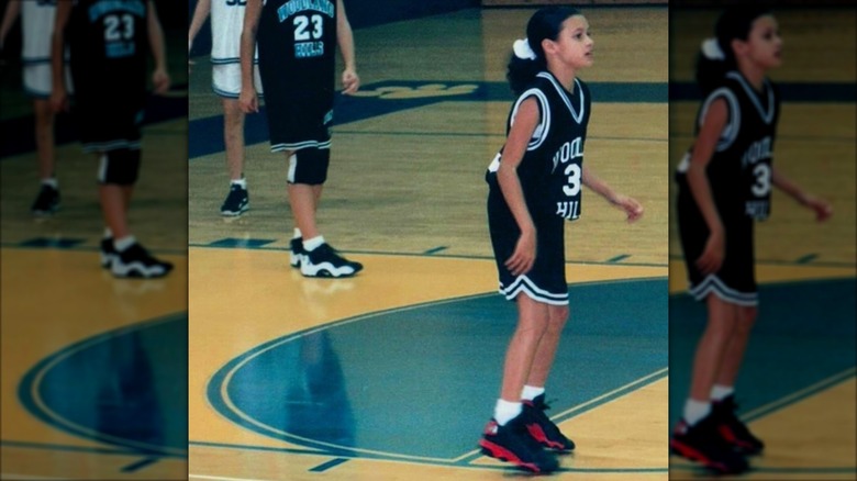 Joy Taylor as a child standing on court during a game