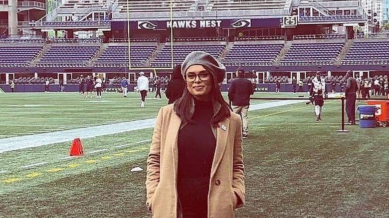 Joy Taylor smiling on the sidelines at her first NFL game reporting