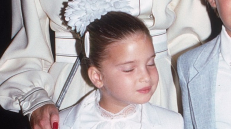 Ivana Trump with a young Ivanka Trump and Donald Trump Jr. at a party