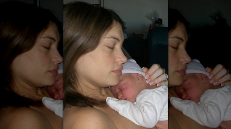 Kimberly Guilfoyle with her eyes closed holding her newborn son on her chest in 2006