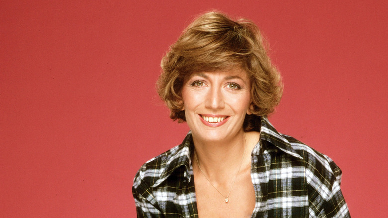 Penny Marshall photographed in front of a red background in 1979