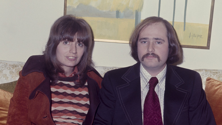 Penny Marshall sitting on a sofa with Rob Reiner