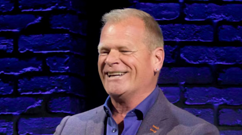 Mike Holmes photographed against a blue background