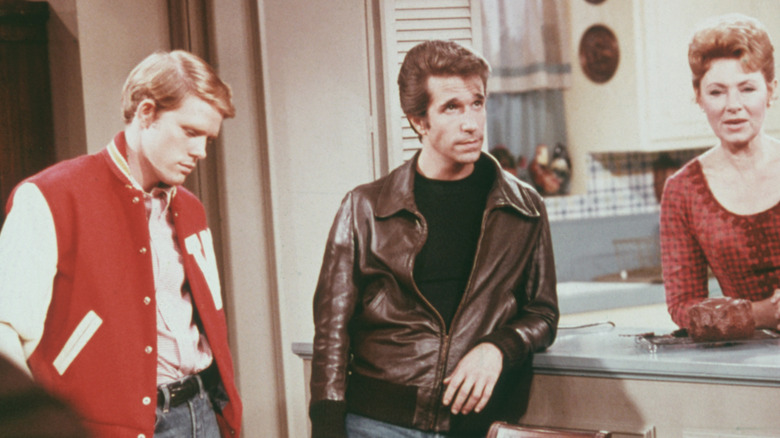 Henry Winkler, as Arthur 'Fonzie' Fonzarelli, Ron Howard as Richie Cunningham, and Marion Ross as Marion Cunningham, in a scene from the television sitcom 'Happy Days', circa 1975.