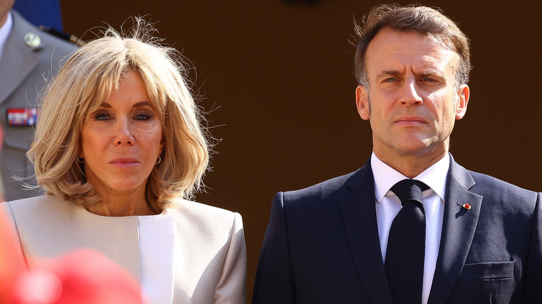 Brigitte Macron standing next to Emmanuel Macron