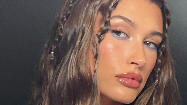 Hailey Bieber looking to side in mirror