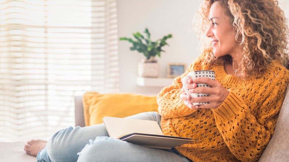 Woman smiling cozy with mug