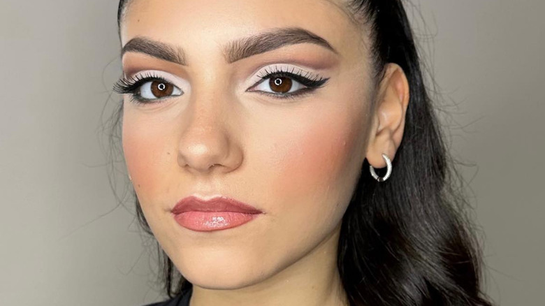 Woman with almond-shaped eyes modeling cut crease eyeshadow