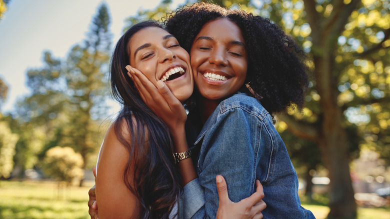 two women hugging friends