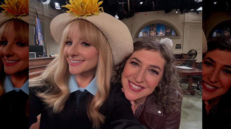 Melissa Rauch, wearing a sunflower hat, poses for a selfie with Mayimm Bialik on the set of Night Court