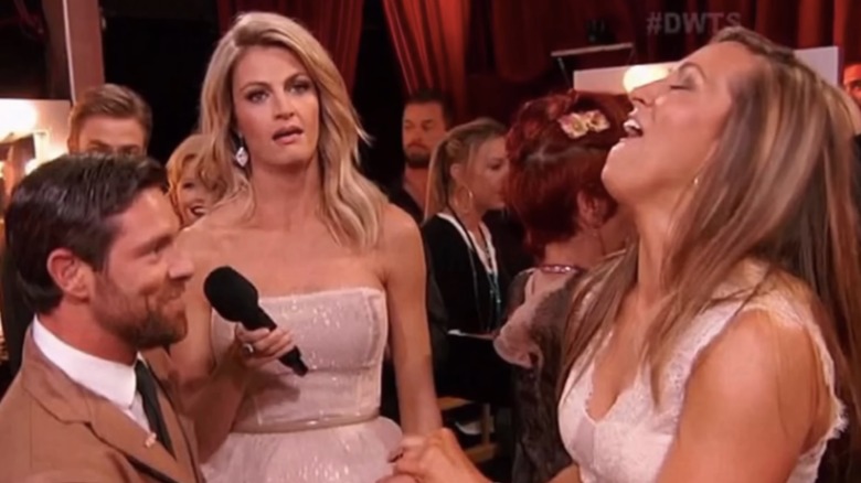 Erin Andrews presumably making a face as Noah Galloway proposes to his girlfriend on air