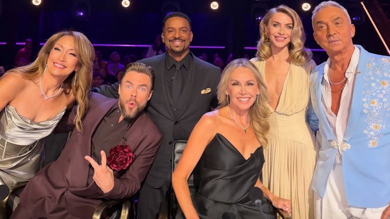 Derek and Julianne Hough with the other presenters and judges on "Dancing with the Stars," all smiling
