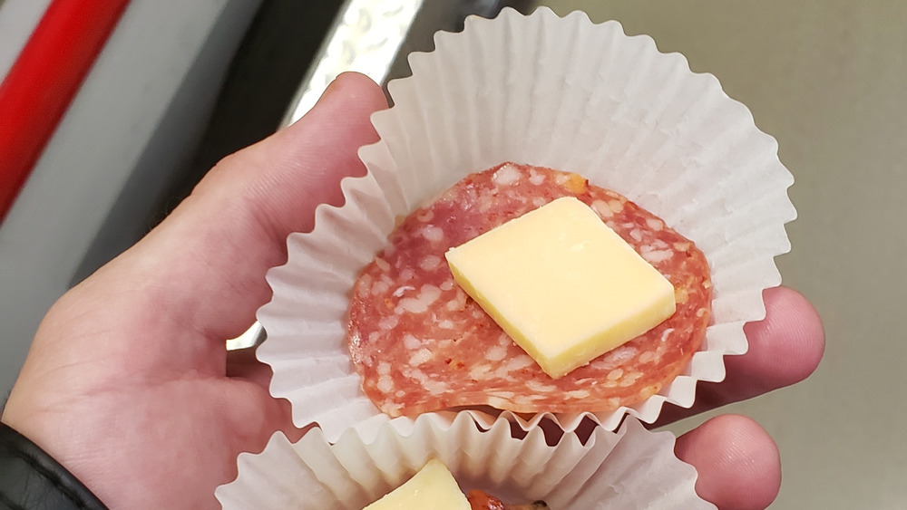 Costco shopper's hand holding a free food sample