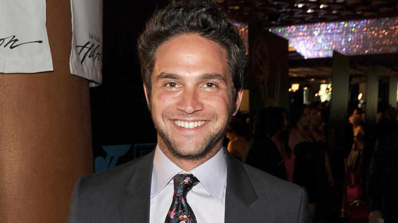Brandon Barash smiles for a photo. 