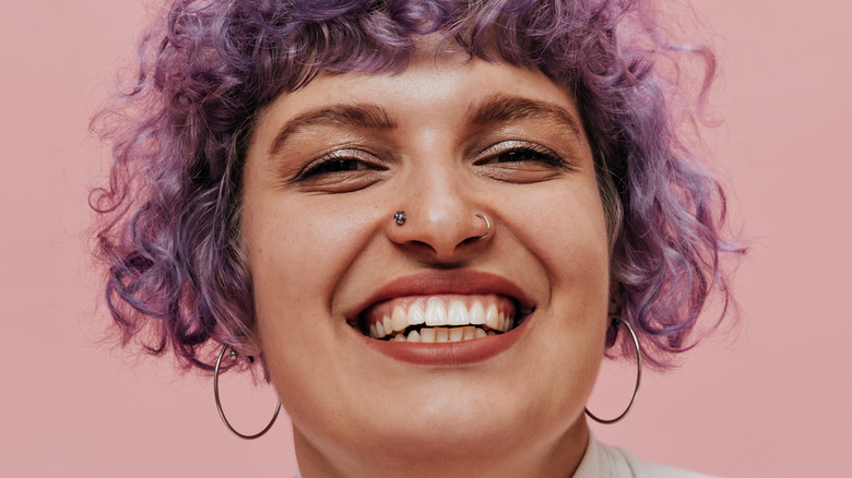 woman smiling with piercings