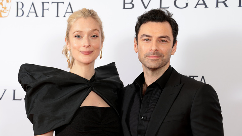 Aidan Turner and Caitlin FitzGerald wearing all black at a BAFTA gala