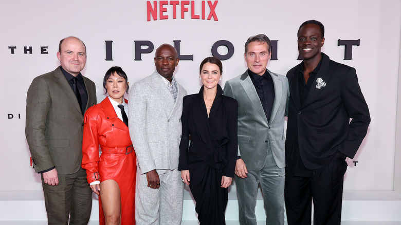 The cast of The Diplomat posing in suits