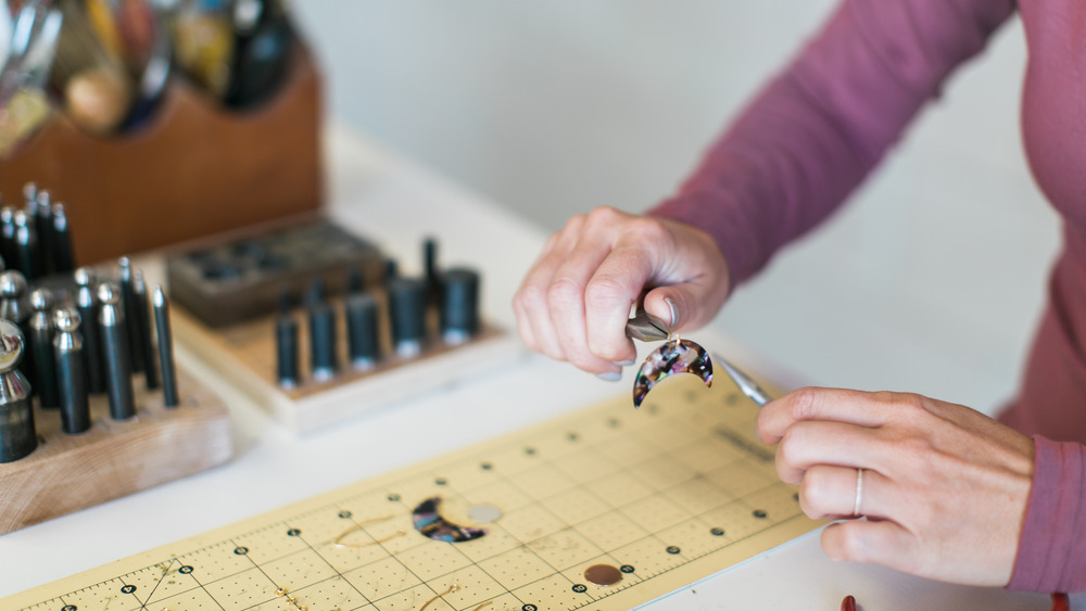 woman making handmade jewelry