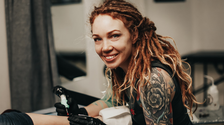 female tattoo artist smiling