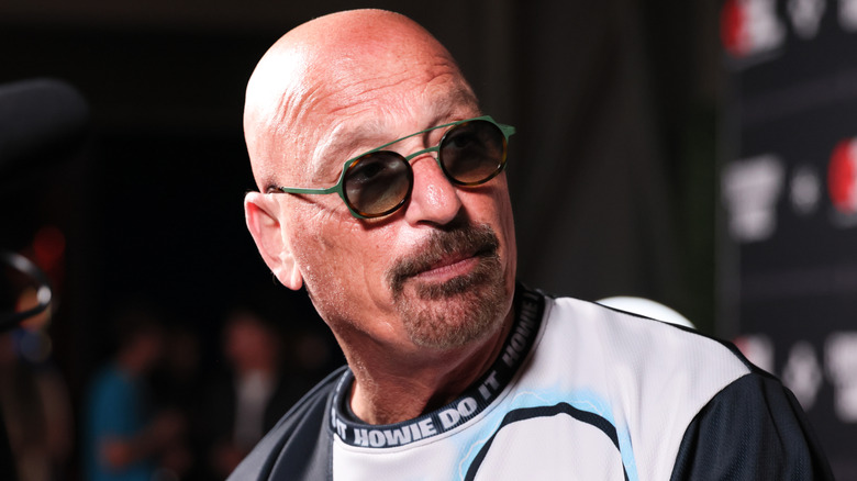 Howie Mandel frowning in sunglasses.