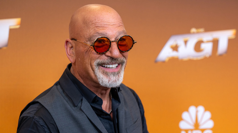 Howie Mandel smiling in sunglasses.