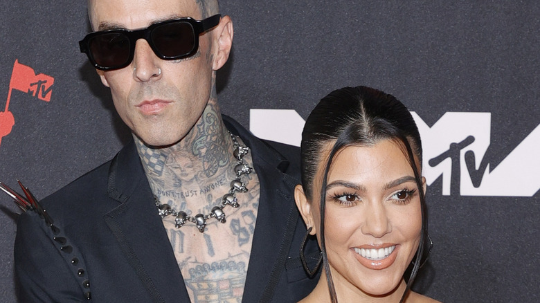 Travis Barker, Kourtney Kardashian posing