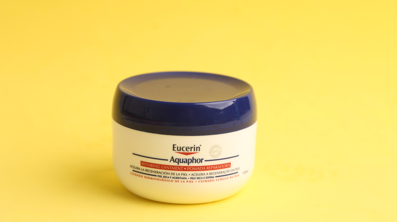 eucerin cream on yellow backdrop