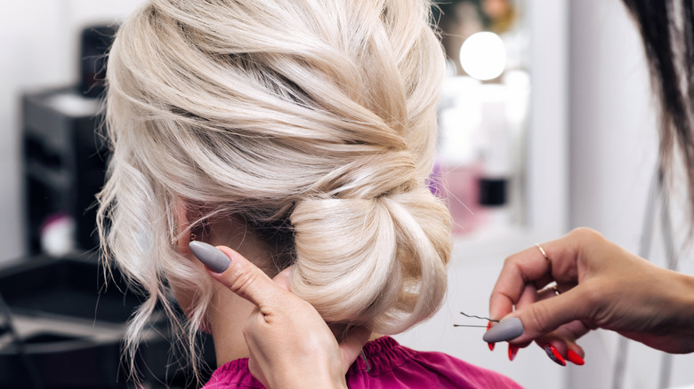 light blond hair tied back in a chignon 